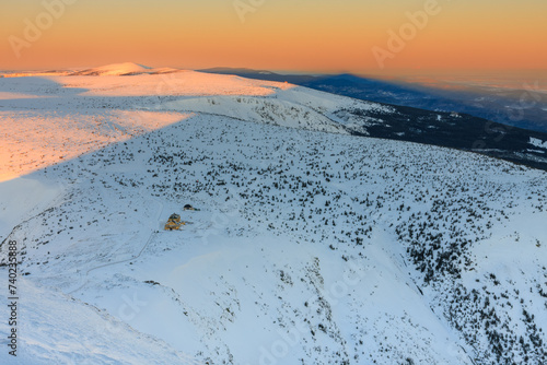Winter, sunrise time, view from Snezka to Silesian house, krkonose mountains. Snezka is mountain on the border between Czech Republic and Poland. photo