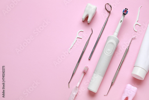 Dental tools and oral hygiene supplies on pink background. World Dentist Day