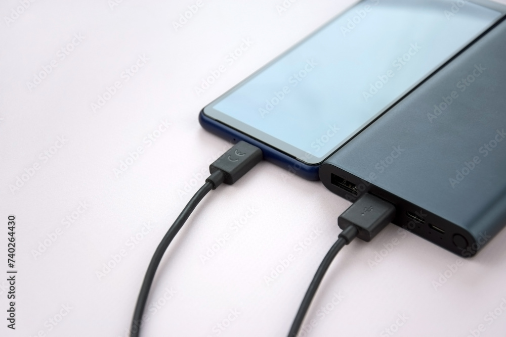 Power bank for charging mobile devices. Black smart phone charger with power bank. Power bank for charging mobile devices. Black smart phone charger with power bank.