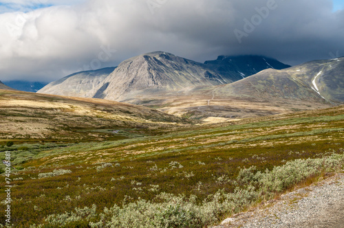 Rondane National Park - a hilly landscape with a meadow and high mountains in Norway in the north of Europe in Scandinavia