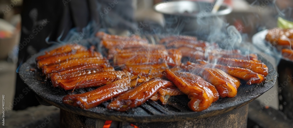 Several hot dogs are being cooked on a grill, creating a delicious and savory aroma.