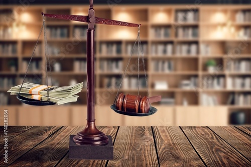 Wooden desk in courtroom, money and material concept photo
