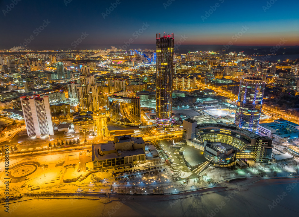 Fototapeta premium Yekaterinburg city with Buildings of Regional Government and Parliament, Dramatic Theatre, Iset Tower, Yeltsin Center, panoramic view at winter sunset.