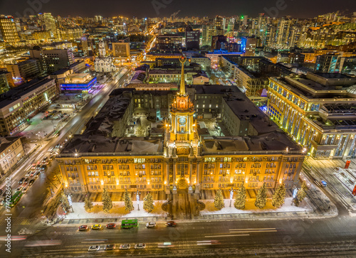 Yekaterinburg City Administration or City Hall and Central square at winter nigh. Night city in winter or early spring. Aerial View.