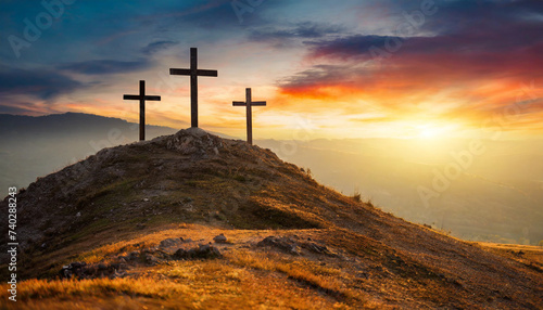 Three crosses on hill at sunset, symbolizing Crucifixion of Jesus Christ. Religious concept with space for caption photo