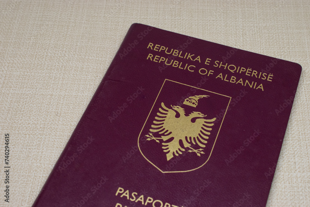 Close up photos of Greek-Albanian passports with some cash. Traveling concept, creamy backround. Top view. Close up photos of Greek-Albanian passports with some cash. Traveling concept, creamy backround. Top view.