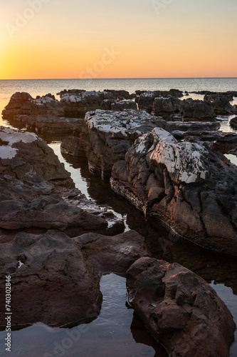 Rocks on sea in sunset