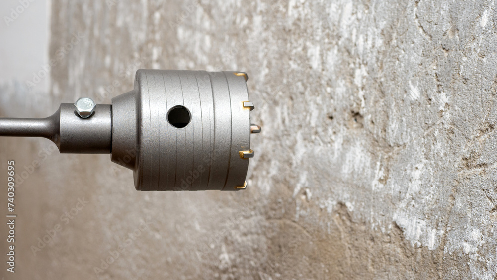 Installation of sockets in the house. A hammer drill with a drill for ...