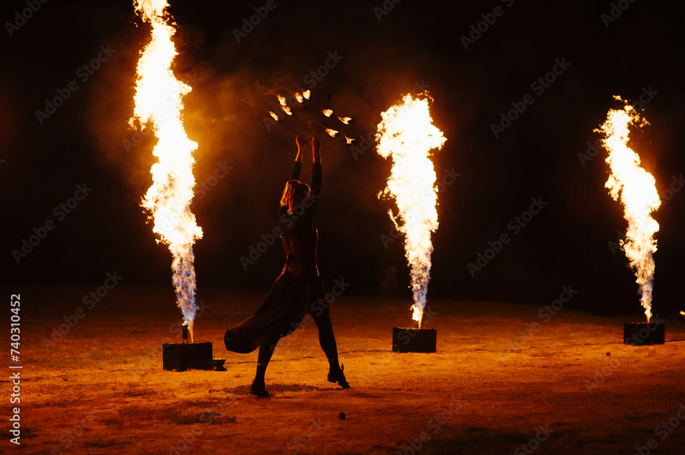 People dance a passionate dance with a fiery spinning wheel in hand