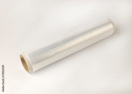 A roll of cling film. Cellophane packing tape on a white background. The concept of product packaging and storage.