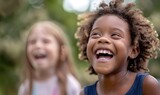 A joyful multiethnic children laughing together, sunny outdoor setting