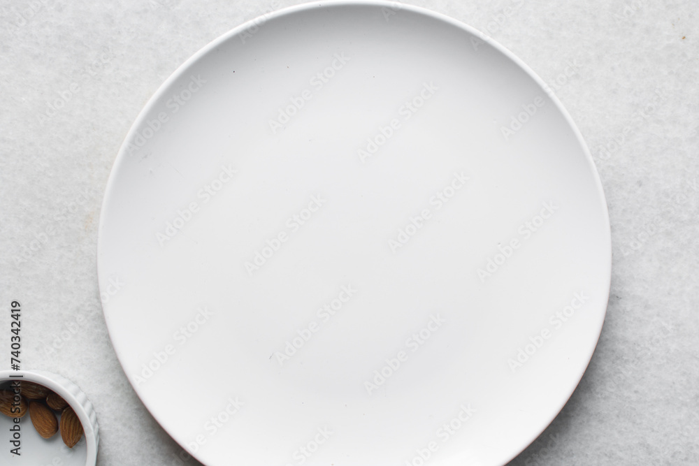 Top view of white ceramic plates on a marble table, white ceramic minimalist white plate Top view of white ceramic plates on a marble table, white ceramic minimalist white plate