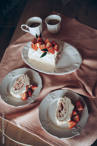 meringue cake combined with fresh strawberries on a background of a pink tablecloth