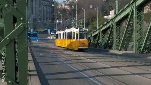 Yellow tramway on hungary freedom bridge. A view of Freedom bridge with crossing yellow tramcar during day time.