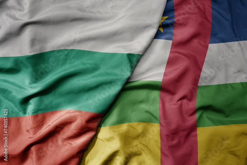 big waving national colorful flag of central african republic and national flag of bulgaria .