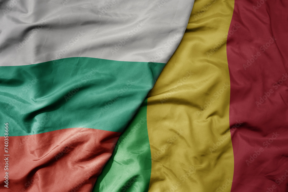 big waving national colorful flag of mali and national flag of bulgaria .