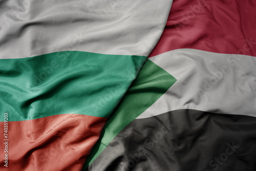 big waving national colorful flag of sudan and national flag of bulgaria .