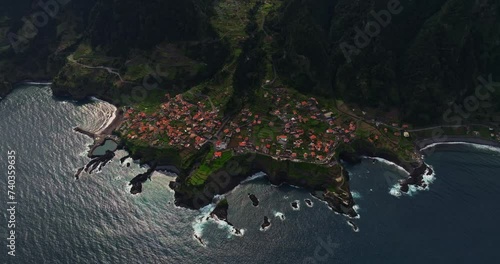 Incredible drone view of the small town of Seixal located on the leaked volcanic rock many years ago. Seixal a Small Municipality in Madeira, Portugal  photo