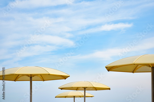 Yellow sun shade umbrellas with blue sky at Toronto HTO Park photo