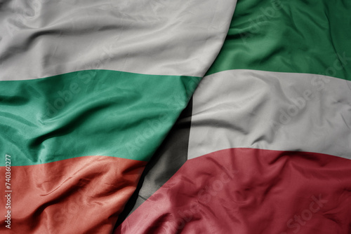 big waving national colorful flag of kuwait and national flag of bulgaria .