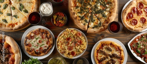 A table covered with a variety of different types of pizza, showcasing the diverse menu offerings at Delicious Pizz Restaurant.