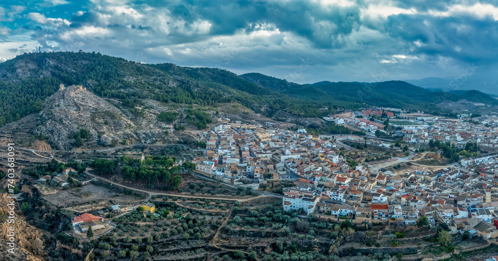 Aerial view of Pliego town and medieval castle in Southern Spain, ruined walls made of rammed earth with Arab origin