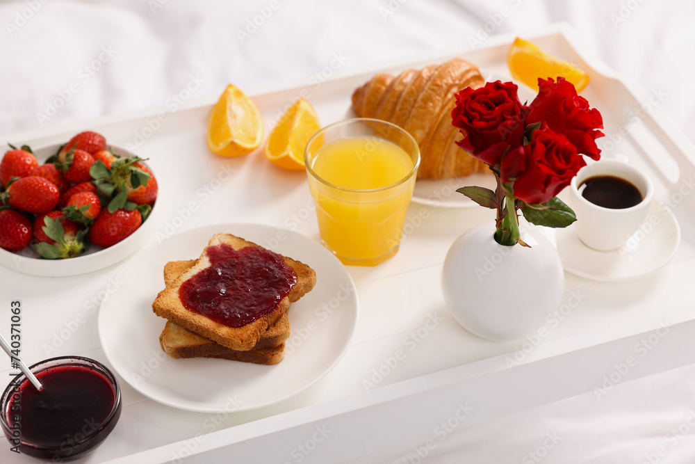Tray with delicious breakfast on bed, closeup Tray with delicious breakfast on bed, closeup
