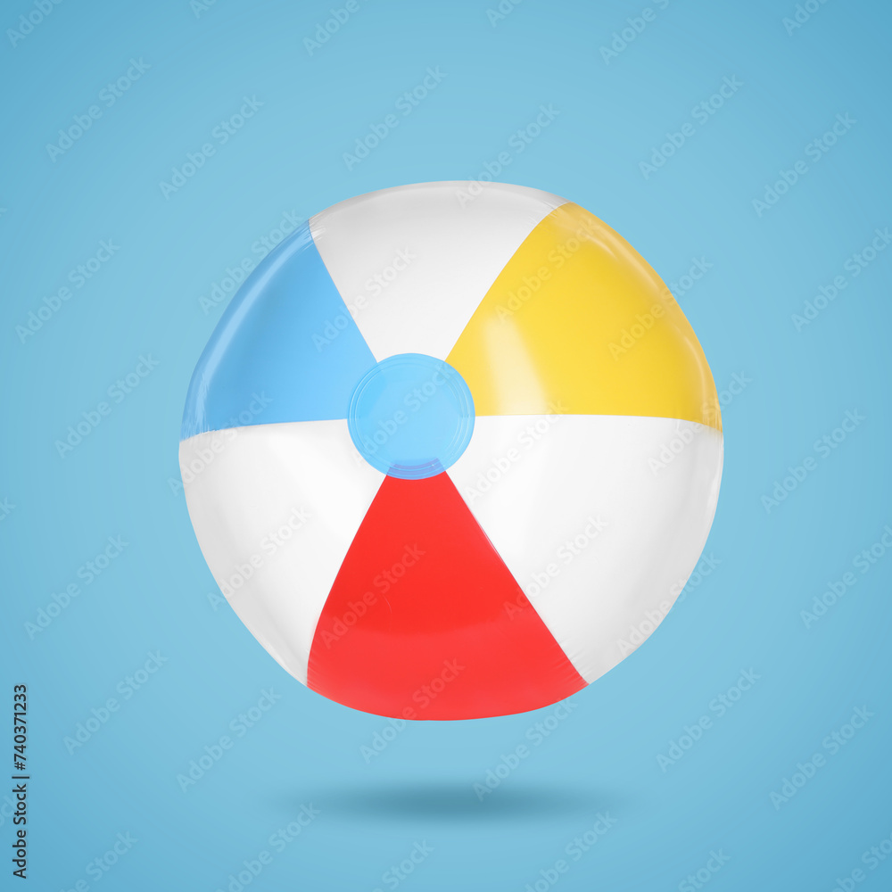 Obraz premium One beach ball in air on light blue background