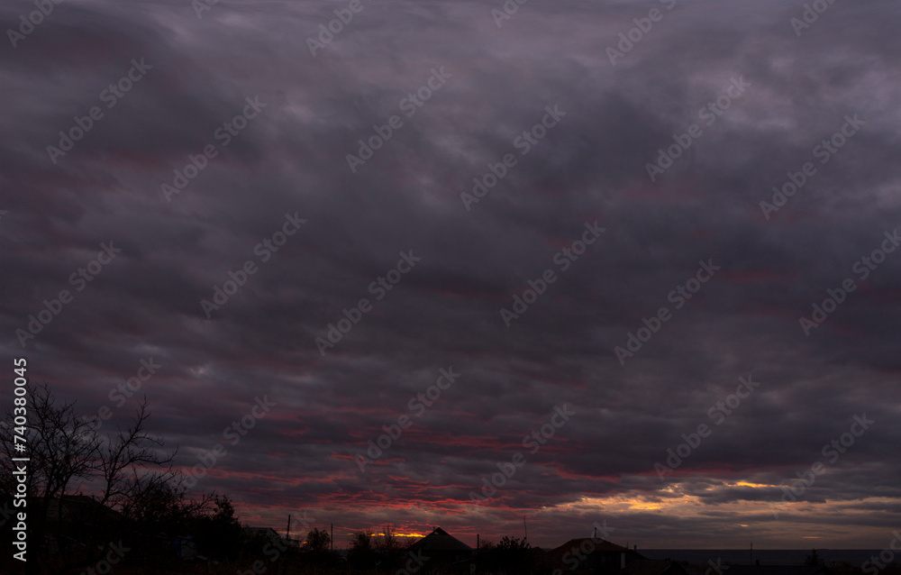 Obraz premium Landscape at sunset. Tragic gloomy sky. Panorama. Crimson twilight.