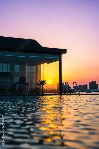 Infinity swimming pool in the resort at sunset