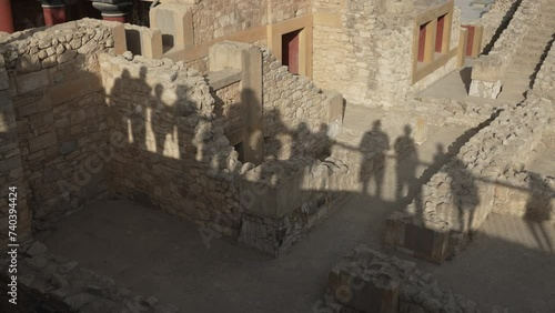 silhouettes of human shadows on a wall in the archaeological site of Knossos, Greece photo