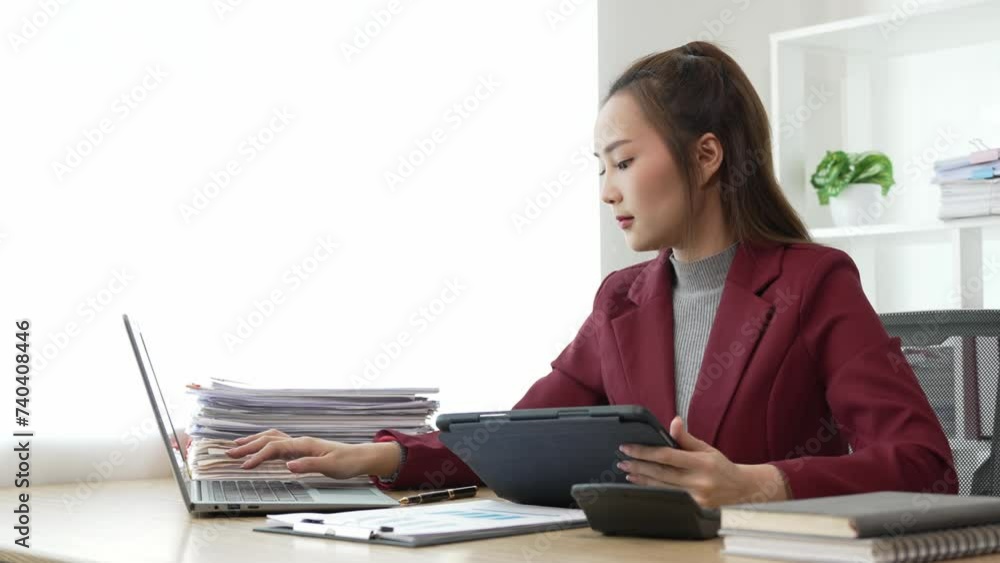 Asian business woman working at office with documents on table Planning to analyze financial reports business plan investment Young Asian woman accounting for sales invoices Asian business woman working at office with documents on table Planning to analyze financial reports business plan investment Young Asian woman accounting for sales invoices