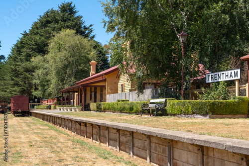 Historic building and the platform of Trentham railway station with some old carriages nearby. It was opened in 1880 and closed in 1978 in Victoria, Australia.