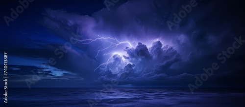 Dramatic lightning storm over the vast ocean during the night with dark cloudy sky