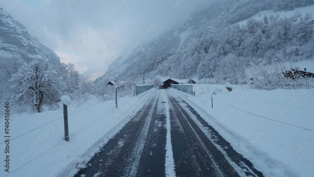 POV walk in snowy Lauterbrunnen, Switzerland, showcasing winter's charm with falling snow and majestic mountain views in the valley POV walk in snowy Lauterbrunnen, Switzerland, showcasing winter's charm with falling snow and majestic mountain views in the valley