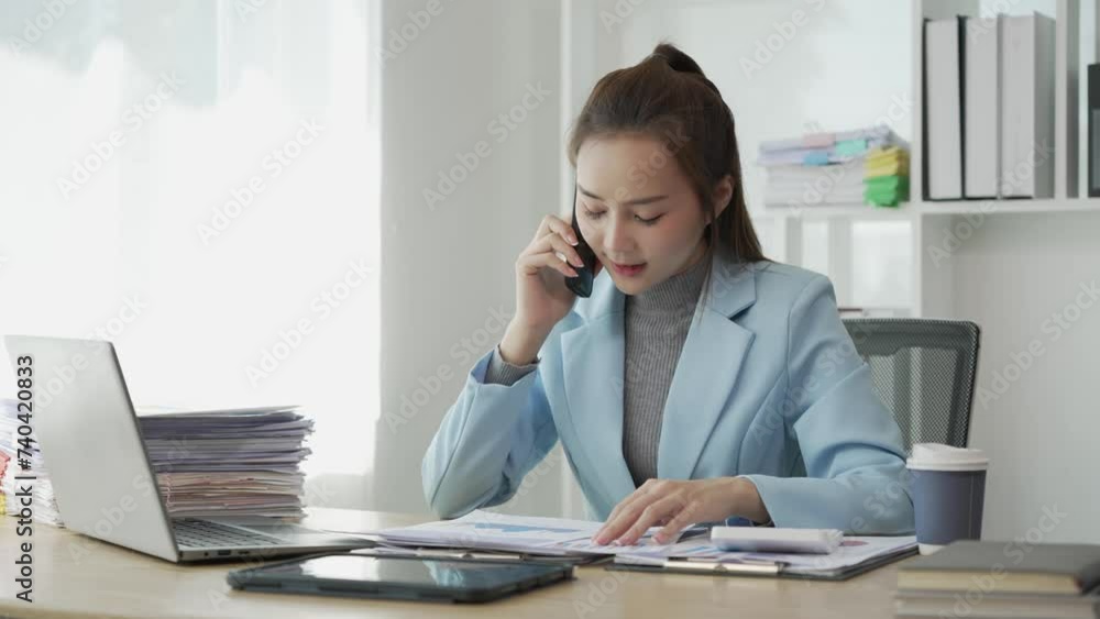 Asian business woman working at office with documents on table Planning to analyze financial reports business plan investment Young Asian woman accounting for sales invoices Asian business woman working at office with documents on table Planning to analyze financial reports business plan investment Young Asian woman accounting for sales invoices