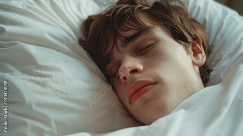 Serene young man captured in a peaceful close-up while sleeping in bed