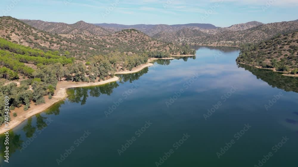 Picturesque aerial view of Sierra de Andujar nature reserve and Encinarejo reservoir blue waters 