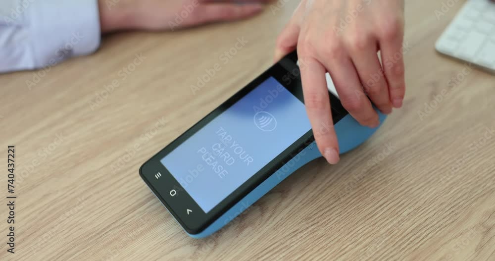 Seller cashier shows touch screen terminal and tap your card Seller cashier shows touch screen terminal and tap your card