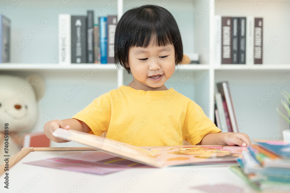 Happy Asian children relax read book at home. daughter and reading a story. learn development, childcare, laughing, education, storytelling, practice, imagine, reduce addiction mobile phone Happy Asian children relax read book at home. daughter and reading a story. learn development, childcare, laughing, education, storytelling, practice, imagine, reduce addiction mobile phone