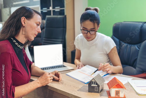 Businesswoman real estate house agent discuss to customer. Team diversity women selling house real estate agent at office desk. Women working home insurance mortgage sale apartment realtor dealership