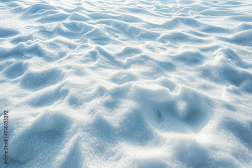 Beautiful Winter Background with Snowy Ground: Natural Snow Texture with Wind-Sculpted Patterns on the Snow Surface.