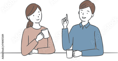 飲み物を飲みながら会話をするカップル