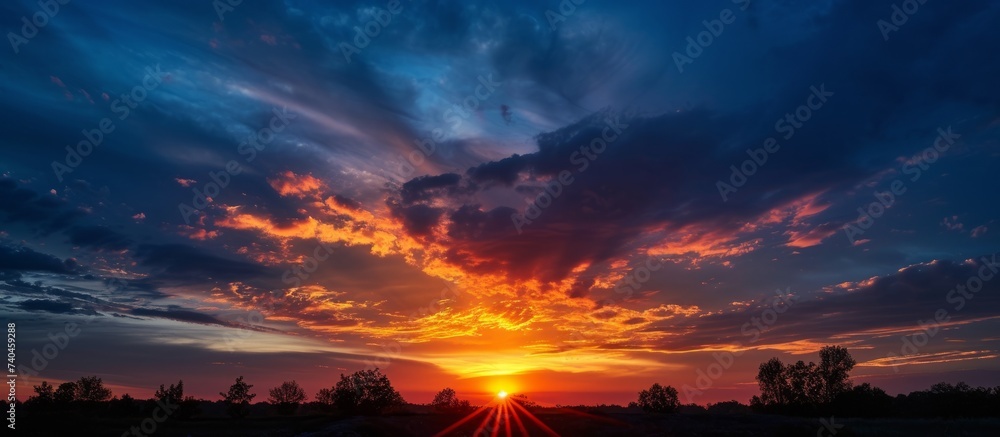 Majestic sunset with a dazzling orange sun shining through the dramatic clouds Majestic sunset with a dazzling orange sun shining through the dramatic clouds