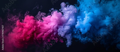 Vibrant and colorful swirling smoke over dark black background for creative design projects