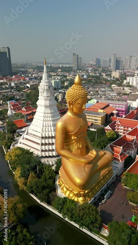 Aerial view of the Giant Golden Buddha in Bangkok with a beautiful city skyline in the background. photo