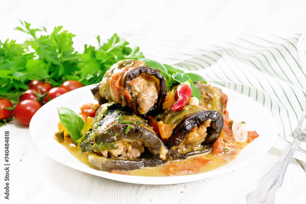 Rolls of eggplant with mincemeat in plate on table Rolls of eggplant with mincemeat in plate on table