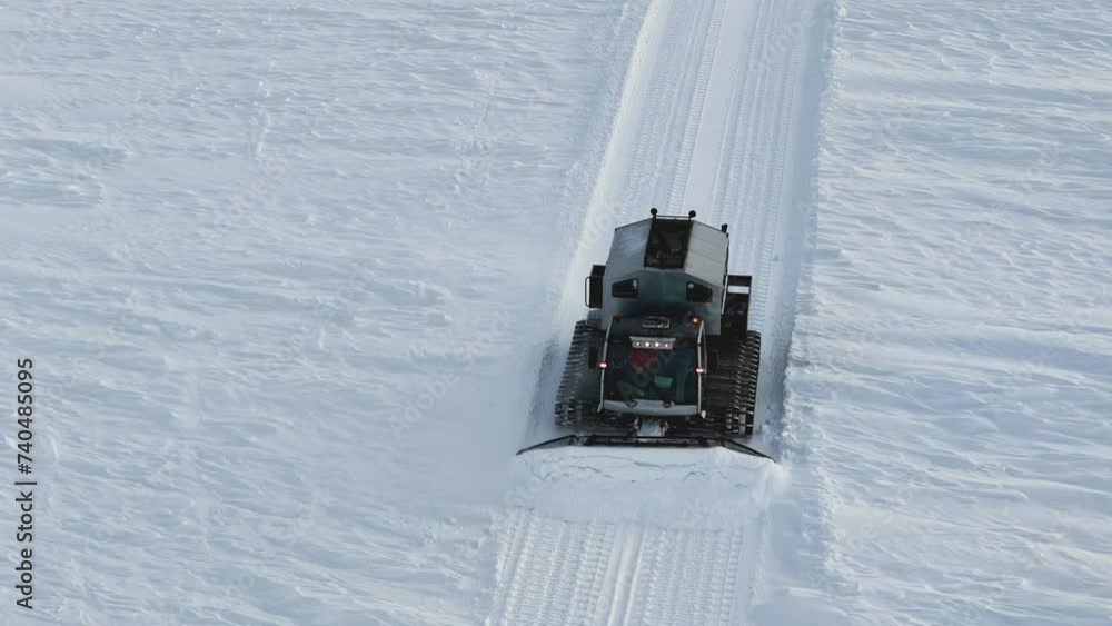 Snowcat smoothing ski slopes ensuring ideal conditions aerial view Snowcat merging machinery with snowy landscapes. Snowcat's role vital in ski resort maintenance architect of pristine slopes. Snowcat smoothing ski slopes ensuring ideal conditions aerial view Snowcat merging machinery with snowy landscapes. Snowcat's role vital in ski resort maintenance architect of pristine slopes.