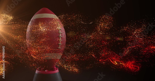 Image of glowing orange particles moving over rugby ball