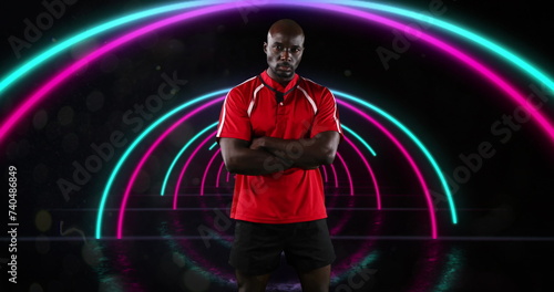 Image of portrait of african american sportsman over pink and blue neon arcs